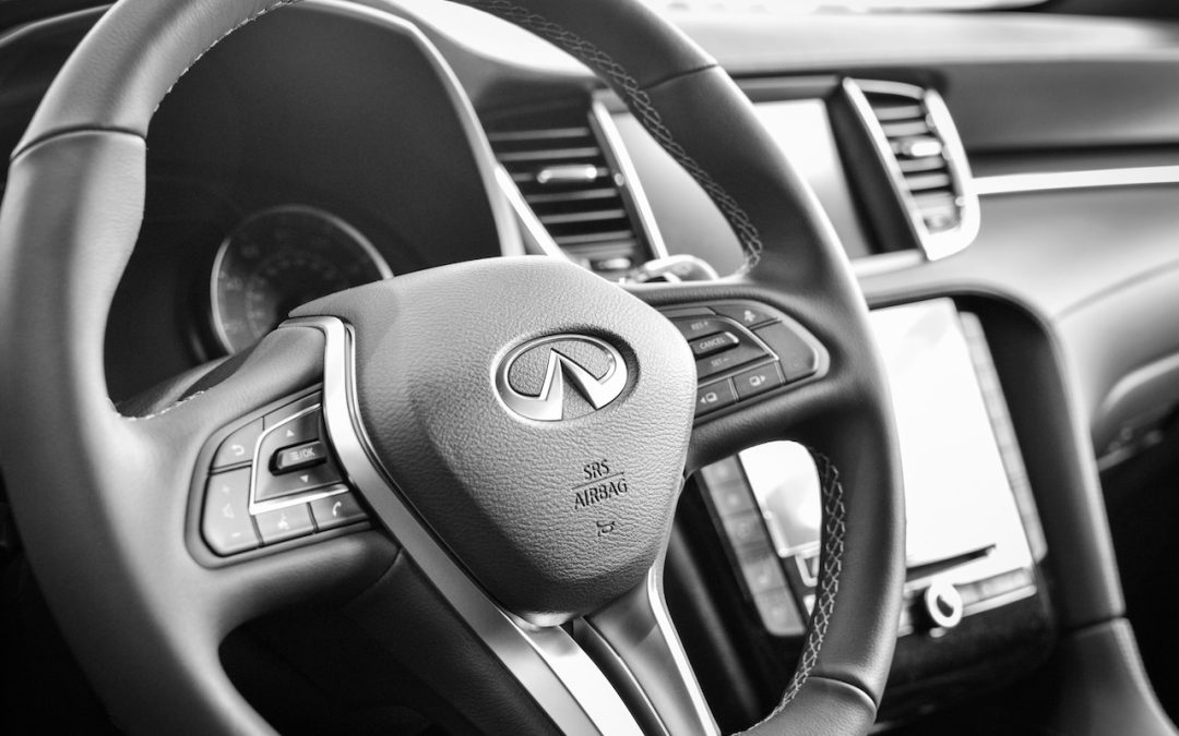 INFINITI steering wheel logo inside luxury vehicle repaired at certified collision center in Charlotte NC